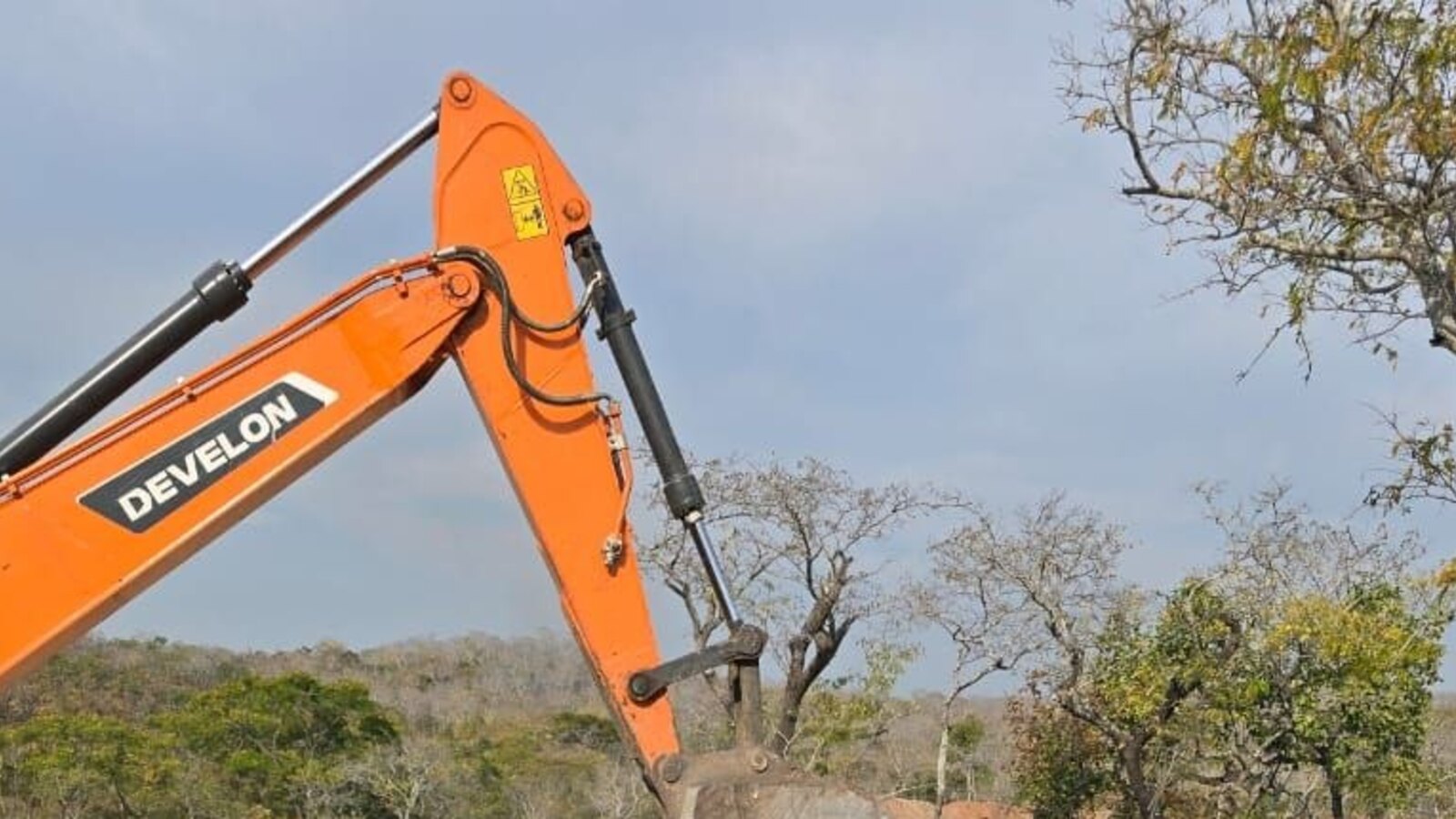Excavator loading mineral material into a haul truck