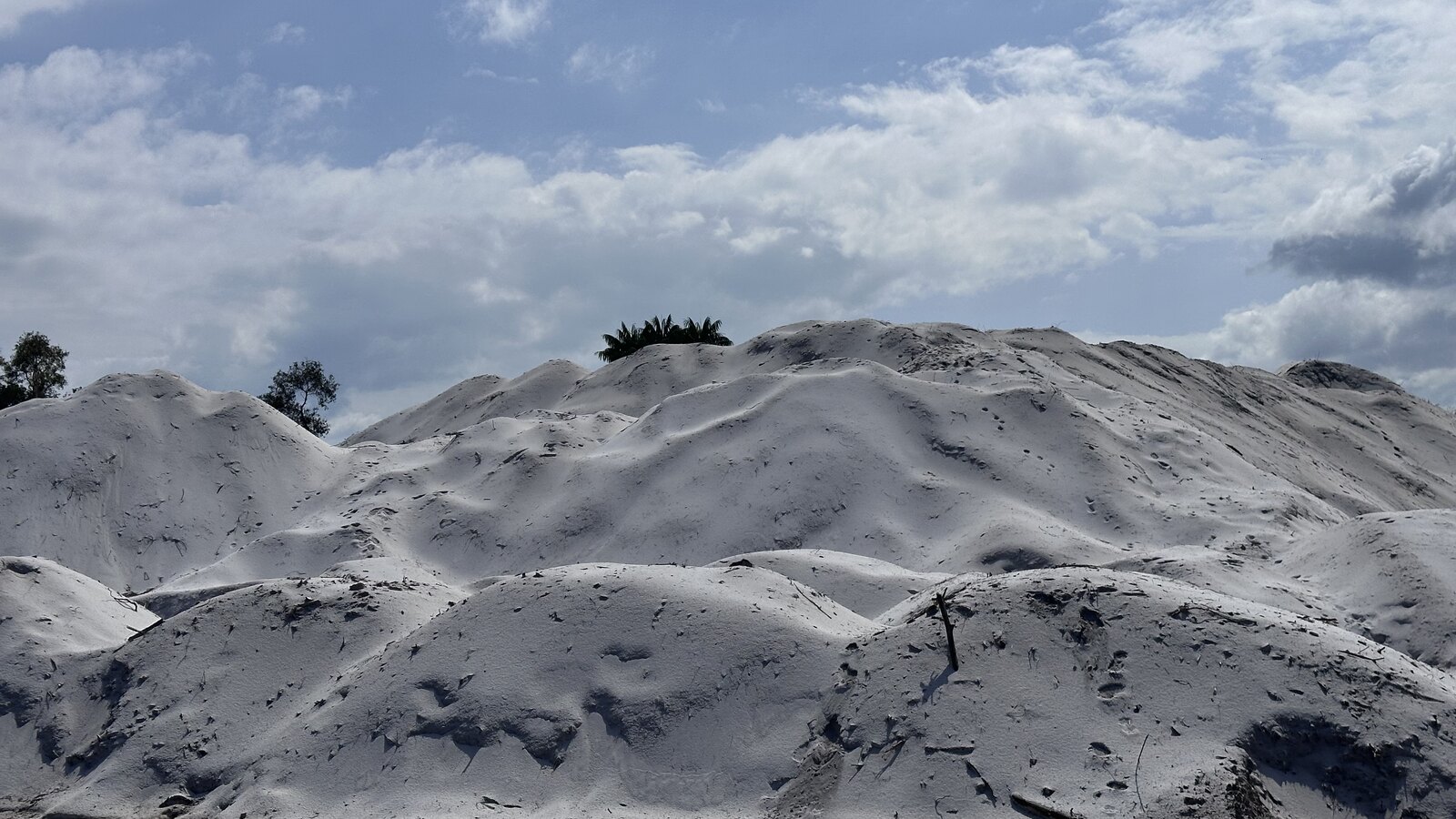 Large processed silica stockpile at an industrial site
